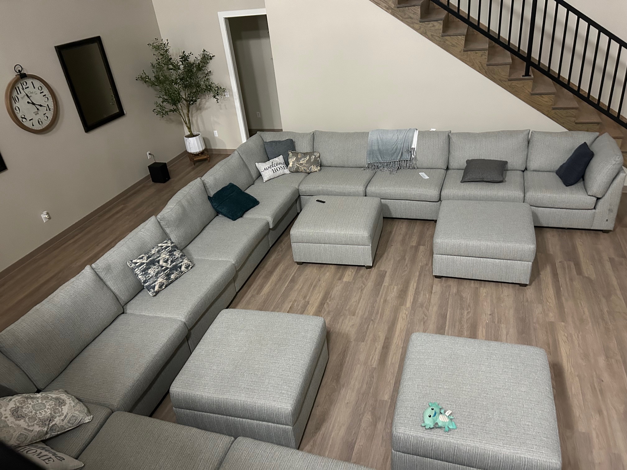 Living Room with Large Sectional Sofa and Staircase