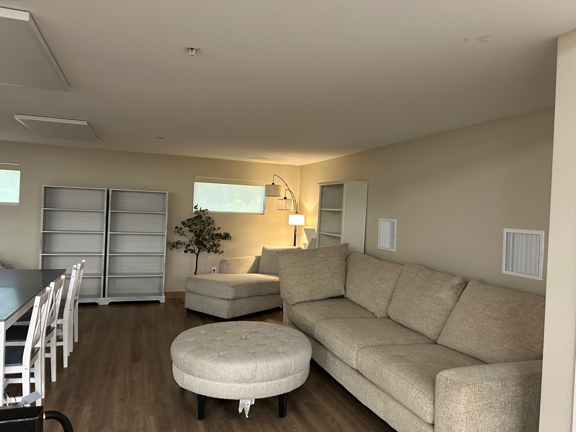 Loft Area with Sectional Sofa, Ottoman, and Bookshelves